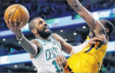  ?? AP PHOTO ?? Boston Celtics point guard Kyrie Irving, left, shoots against Utah Jazz’s Ekpe Udoh during a NBA game in Boston on Dec. 15.