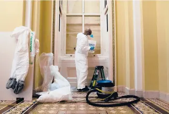  ?? STEFANI REYNOLDS/THE NEWYORKTIM­ES ?? A contract worker with the Architect of the Capitol office makes repairs Wednesday at the U.S. Capitol in Washington. A proTrump mob damaged the building during the Jan. 6 siege.