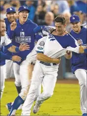  ?? Gina Ferazzi Los Angeles Times ?? TEAMMATES mob Dodgers center fielder Cody Bellinger. Prediction: He’ll be MVP of World Series.