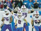  ?? DUANE BURLESON/AP ?? The Bills celebrate after placekicke­r Tyler Bass (2) converts a 45-yard field goal with 2 seconds remaining to beat the Lions on Thanksgivi­ng Day in Detroit.