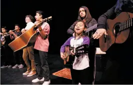  ?? Michael Macor / The Chronicle ?? Members of the mariachi band, including Gina Gonzalez, 7, rehearse for “Between Dirt & Sky,” a musical play about Cesar Chavez, leader of the United Farm Workers, presented by Brava Theater and the Mission Academy of Performing Arts.