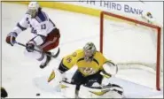  ?? MARK HUMPHREY — ASSOCIATED PRESS ?? New York Rangers right wing Kevin Hayes (13) jumps out of the way of a shot as Nashville Predators goalie Pekka Rinne (35), of Finland, gets set to block it in the second period of the game Saturday, in Nashville, Tenn.