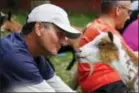  ??  ?? Greg Wong looks at a goat during a goat yoga session.