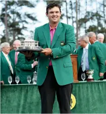  ?? — AFP ?? Patrick Reed of the United States poses with the trophy after winning the 2018 Masters Tournament at the Augusta National Golf Club on Sunday in Georgia.