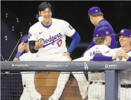  ?? Lee Jin-man Associated Press ?? DODGERS DH Shohei Ohtani, shown in the dugout Sunday, has expressed an eagerness to play the field this season. “I think it’s important to be ready,” he said.