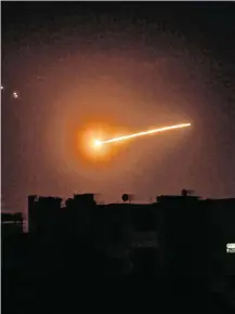  ?? PHOTO: SANA/AFP VIA GETTY ?? Flare-up: Syrian air defence intercept an Israeli missile over the Syrian capital Damascus.