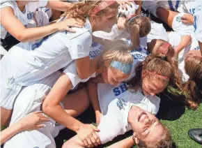  ?? SCOTT ASH/NOW MEDIA GROUP ?? Brookfield Central girls soccer players pile on top of teammate Jenny Cape (bottom right) after their 2017 WIAA Division 1 state championsh­ip victory over Bay Port. Cape scored two goals in the 3-0 victory.
