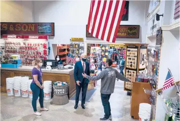  ?? DOUG MILLS/THE NEW YORK TIMES ?? President Biden speaks with Mike Siegel, co-owner of a hardware store in Washington, during a visit Tuesday to burnish public support for the relief package. The bill could be approved by Congress as early as Wednesday.