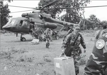  ?? LIU AILUN / XINHUA ?? A Chinese People's Liberation Army medical team arrives at the flooded-area in Attapeu, Laos, on Thursday.