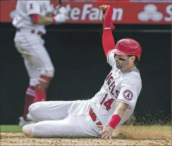  ?? Alex Gallardo Associated Press ?? THE ANGELS’ TYLER WADE, the speedster acquired from the New York Yankees last November, slides home safely during the seventh inning. The Angels’ victory completed a 5-2 homestand.
