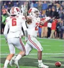  ?? RICK WOOD/MILWAUKEE JOURNAL SENTINEL ?? Jonathan Taylor and Danny Davis were two of the Badgers' stars Saturday in the victory over Purdue.