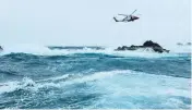  ?? U.S. Coast Guard ?? U.S. Coast Guard crews in a 33-foot Special Purpose Craft and a MH-60T Jayhawk helicopter rescued a fisherman from rocks off Dog Island in U.S. Virgin Islands waters.