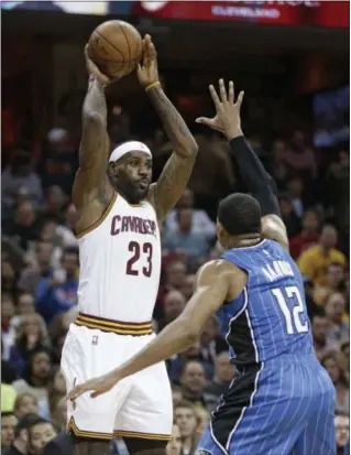  ?? TONY DEJAK — ASSOCIATED PRESS ?? LeBron James passes while the Magic’s Tobias Harris defends in the first half Nov. 23 at The Q.