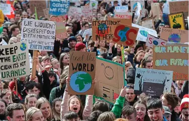  ??  ?? School’s out: Pupils taking to the streets to raise awareness of climate change fears