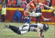  ?? ED ZURGA / AP ?? Kansas City Chiefs tight end Travis Kelce vaults Denver Broncos safety Justin Simmons during the second half of Sunday’s game in Kansas City, Missouri. The Chiefs won 33-10.