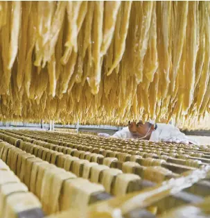  ?? AP FOTO ?? QUALITY CONTROL. A worker checks on soybeans at a processing factory in Xiaotun Township of Dafang County in Bijie, Guizhou Province.