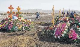 ?? Sergei Gavrilenko ?? The Associated Press A fresh row of graves Thursday at a cemetery on the outskirts of the Siberian city of Kemerovo are marked March 25, the date of a shopping mall fire that killed 64 people.