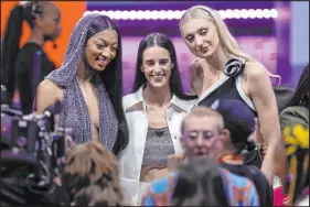  ?? Adam Hunger The Associated Press ?? First-round picks, from left, Angel Reese, Caitlyn Clark and Cameron Brink pose for a photo before the start of the WNBA draft.