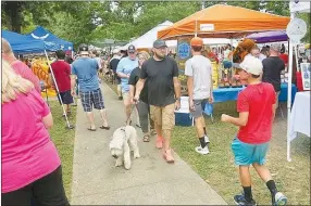  ?? Westside Eagle Observer/SUSAN HOLLAND ?? The sidewalks in Kindley Park were seeing lots of traffic Saturday as Gravette Day visitors walked up and down viewing all the booths set up there. Vendors reported seeing good results as citizens were eager to come out after missing the event last year.