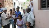  ?? — BIPLAB BANERJEE ?? A Muslim family stands outside their house at Bishada village in Dadri on Tuesday.