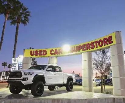  ?? Mario Tama/Getty Images ?? Used cars are displayed for sale at an auto dealership last week in Glendale, Calif. AutoNation says it expects prices for new and used cars to drop this year as manufactur­ers produce more inventory and offer more incentives.