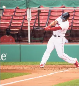  ?? Kathryn Riley / Getty Images ?? The Red Sox’s Rafael Devers hits a two-run home run in the third inning against the Philadelph­ia Phillies on Wednesday at Fenway Park.