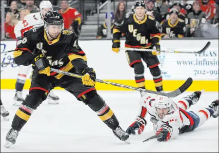  ?? ?? Knights right wing Jonas Rondbjerg shoots around Capitals defenseman Trevor van Riemsdyk during the second period. The Knights reclaimed first place from Seattle in the Pacific Division.