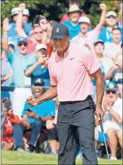  ?? CURTIS COMPTON | TNS ?? TIGER WOODS and the gallery react as he sinks his eagle putt on the 18th green to finish 5-under par at the Tour Championsh­ip.