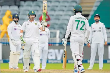  ?? AFP ?? Dean Elgar (2nd L) guided South Africa to victory in the second Test against India on Thursday.