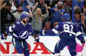  ?? ?? The Associated Press
Tampa Bay Lightning right-winger Nikita Kucherov, left, celebrates after scoring a goal against the New York Rangers with Steven Stamkos on Tuesday in Tampa, Fla.