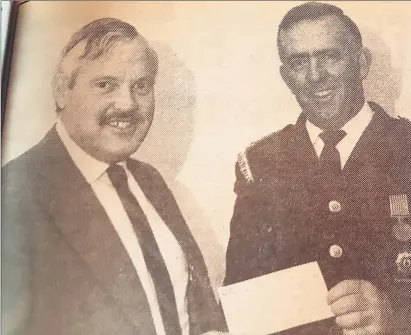  ?? Editorial@campaspene­ws.com.au ?? Tony Keynack from Cooperativ­e Insurances hands over a cheque for $250 to 1987 Rochester Fire Brigade captain Vaughan Thomas. If you have a picture with a history, or one where you need help finding that story, email us at