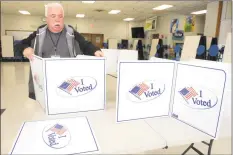  ?? Ned Gerard / Hearst Connecticu­t Media file photo ?? David Sigler assembles partitions while he and others prepare Wooster Middle School for Election Day 2019 voting in Stratford.