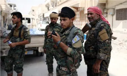  ??  ?? Syrian Democratic Forces: six fighters from the US-backed group were injured in an airstrike denied by Russia. Photograph: Rodi Said/Reuters