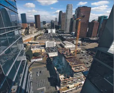  ?? Bob Chamberlin
Los Angeles Times ?? THE RENAISSANC­E HOTEL is planned for downtown Los Angeles on Olympic Boulevard, on the site of a parking lot, bottom left. To the right, work continues on a 24-story tower that will house a Courtyard by Marriott and a Residence Inn by Marriott.