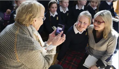  ??  ?? Bridget Cullen taking a picture of Aoife Redden and Cathy Kelly at the launch of ‘Stories for All’ at St Mary’s and St Gerard’s, Enniskerry.