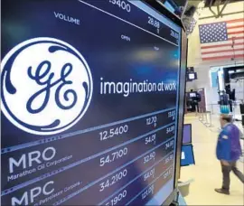  ?? Richard Drew Associated Press ?? GE IS ACCUSED of managing its 401(k) plan for its own benefit by loading it with mutual funds owned by its own subsidiary. Above, at the NYSE in June.