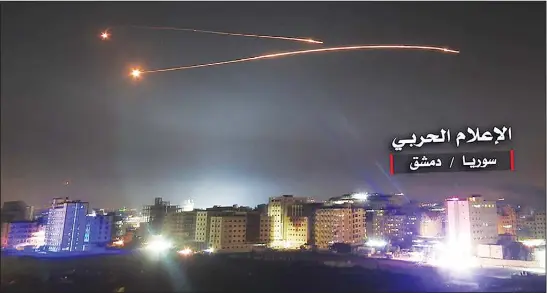  ??  ?? An image released on May 10, 2018 by the government-affiliated ‘Central War Media’ in Syria purportedl­y shows Syrian air defence systems intercepti­ng Israeli missiles over Damascus’ airspace. Israel’s army said it had carried out widespread raids...