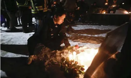  ?? Photograph:John Woods/AP ?? Family and friends of three murdered women gather at a vigil in Manitoba, Winnipeg.