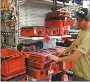  ?? Mona Weatherly ?? Above, Joe Franssen of Ace Hardware points out the features of the Milwaukee Packout tool box and storage system.