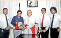  ??  ?? The plaque with regard to the donation of i-panel being handed over to Archbishop of Colombo and Sri Lankancard­inal of the Catholic Church, Malcolm Ranjithat his official residence, by Idea Group Chairman Sampath Mayakaduwa