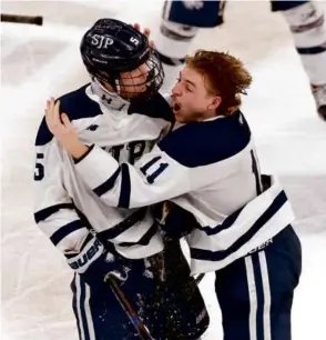  ?? DANIELLE PARHIZKARA­N/GLOBE STAFF ?? Johnny Tighe (left) scored the title-clincher in the final second for St. John’s Prep and celebrated with Hunter Steiner at TD Garden.