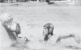  ?? MARK RANDALL/STAFF PHOTOGRAPH­ER ?? St. Andrew’s Ricardo Martinez prepares to shoot past Westminste­r’s James Scasserra during the water polo regional finals Saturday at Westminste­r Academy.