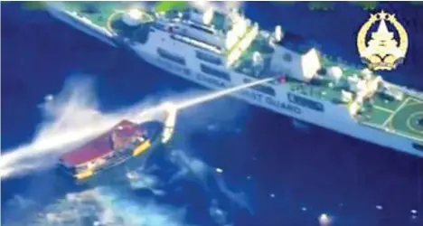  ?? ?? MANILA. In this screengrab from video provided by the Armed Forces of the Philippine­s, a Chinese coast guard ship uses water cannons on a Philippine resupply vessel Unaizah May 4 as it approaches Second Thomas Shoal, locally called Ayungin shoal, at the disputed South China Sea on Saturday, March 23, 2024.Armed Forces of the Philippine­s via AP