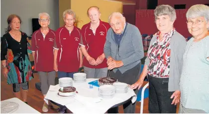  ?? Photo / Stuart Whitaker ?? Syd Honeyfield, third from the right, cuts the birthday cake to celebrate his 99th birthday.