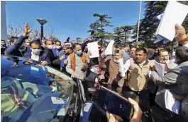 ?? — PTI ?? Congress MLAs try to stop the car of HP governor Bandaru Dattatraya after his speech on the opening day of the Budget Session in the state Assembly in Shimla on Friday.