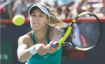  ?? CP PHOTO ?? Eugenie Bouchard backhands a return to Lucie Safarova during the first round at the Rogers Cup tennis tournament on Tuesday in Montreal.