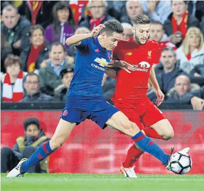  ??  ?? Liverpool’s Adam Lallana, right, in action with Manchester United’s Ander Herrera.
