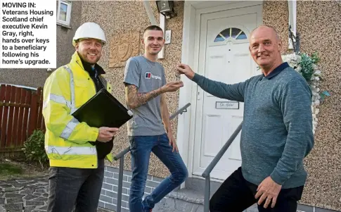  ?? ?? MOVING IN: Veterans Housing Scotland chief executive Kevin Gray, right, hands over keys to a beneficiar­y following his home’s upgrade.