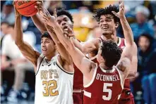  ?? David Zalubowski/Associated Press ?? Colorado guard Nique Clifford pulls in a rebound in front of three Stanford players in Boulder, Colo., on Sunday.