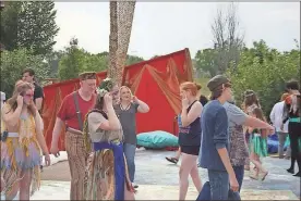  ?? Blake Doss ?? Cast members of the Rome Shakespear­e Festival check their sound connection­s on the Town Green before the Wednesday, June 1, 2016, showing of “A Midsummer Night’s Dream.”